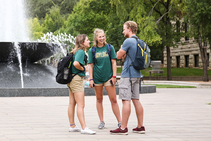 students in front of the fountain