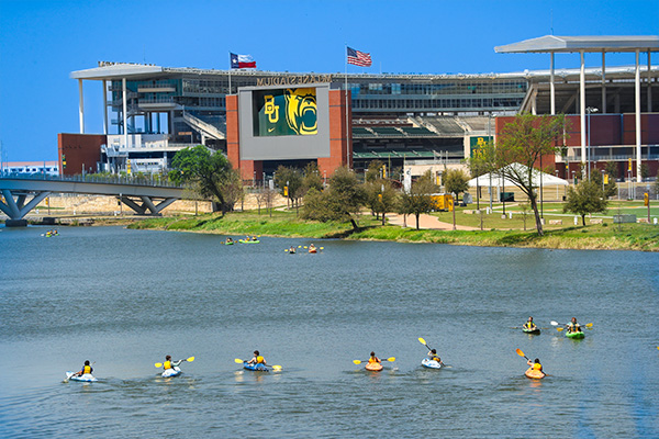 Students kayaking near McLane Stadium